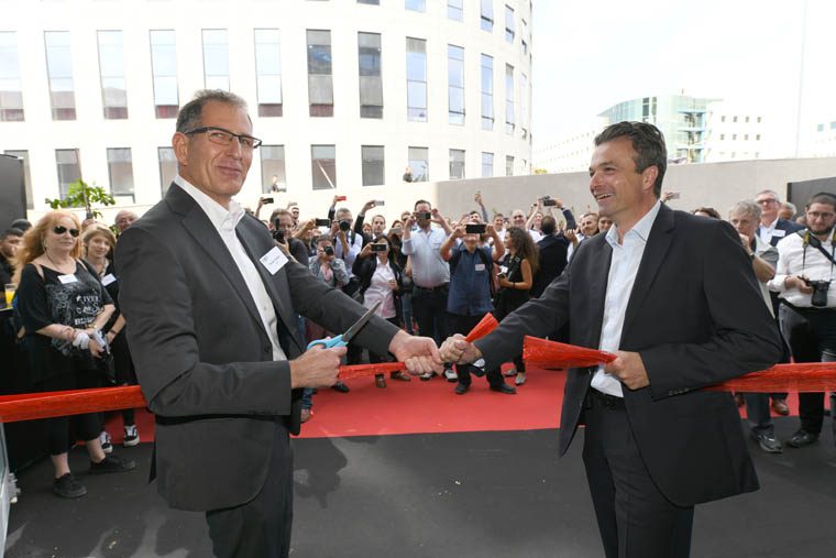 XJet CEO, Hanan Gothait (left), and Straumann VP, Stephan Oehler, cut the ribbon at the grand opening of XJet’s AM Center. Photo via XJet.