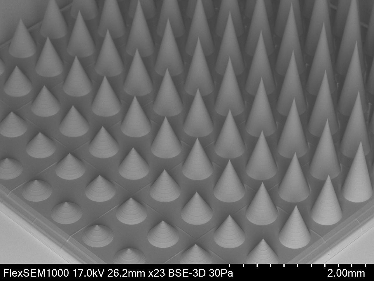 An array of micro-needles with individual base diameters of 500µm and varying heights from 260µm to 2,000µm fabricated using adaptive resolutions. Image via UpNano.