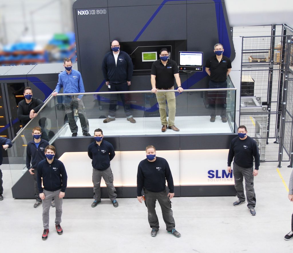 A team of SLM engineers being trained in Lubeck to use the NXG XII 600 3D printer.