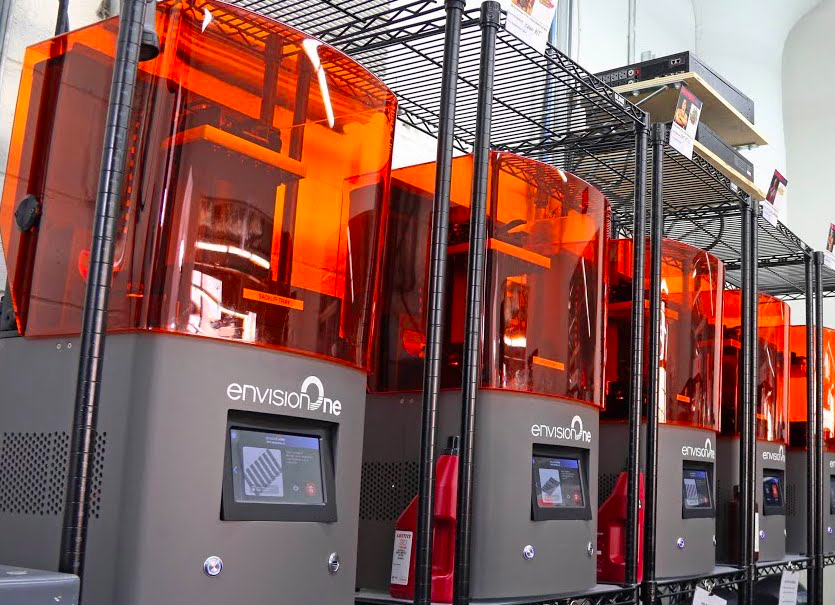 A row of EnvisionOne 3D printers. 