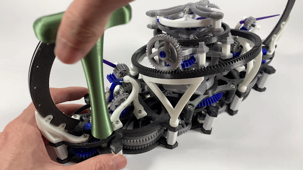 The assembly is powered solely by winding its spring. GIF via MyMiniFactory.