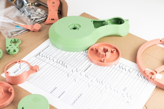 The SongBird turntable's 3D printed parts along with the kit's packing instructions.