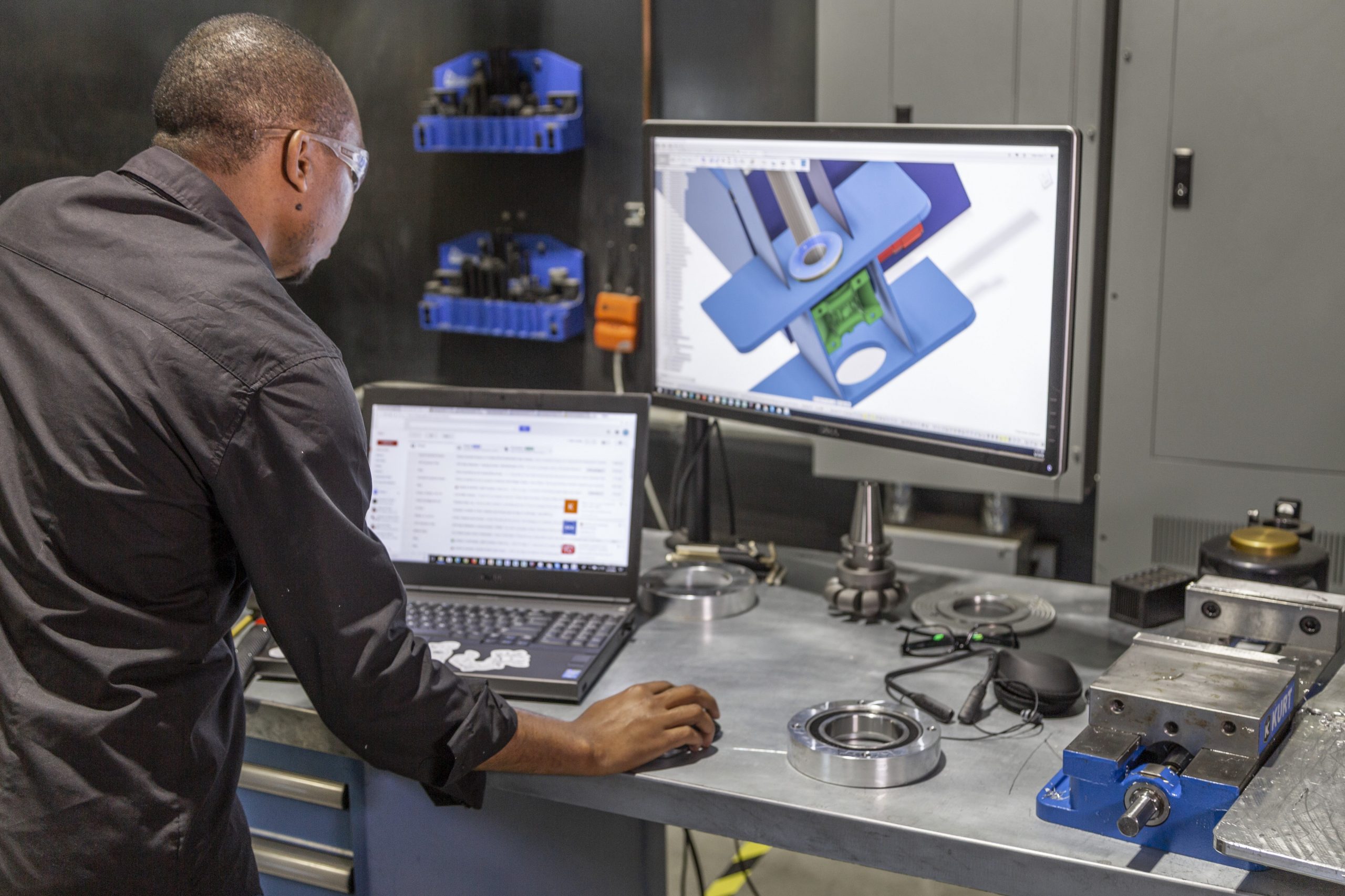 An engineer using Autodesk's Fusion 360 software.