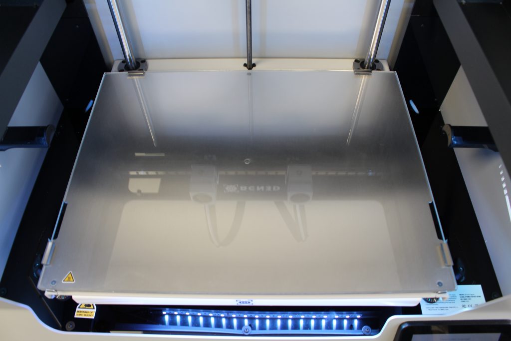 The glass-covered aluminum build plate. Photo by 3D Printing Industry.