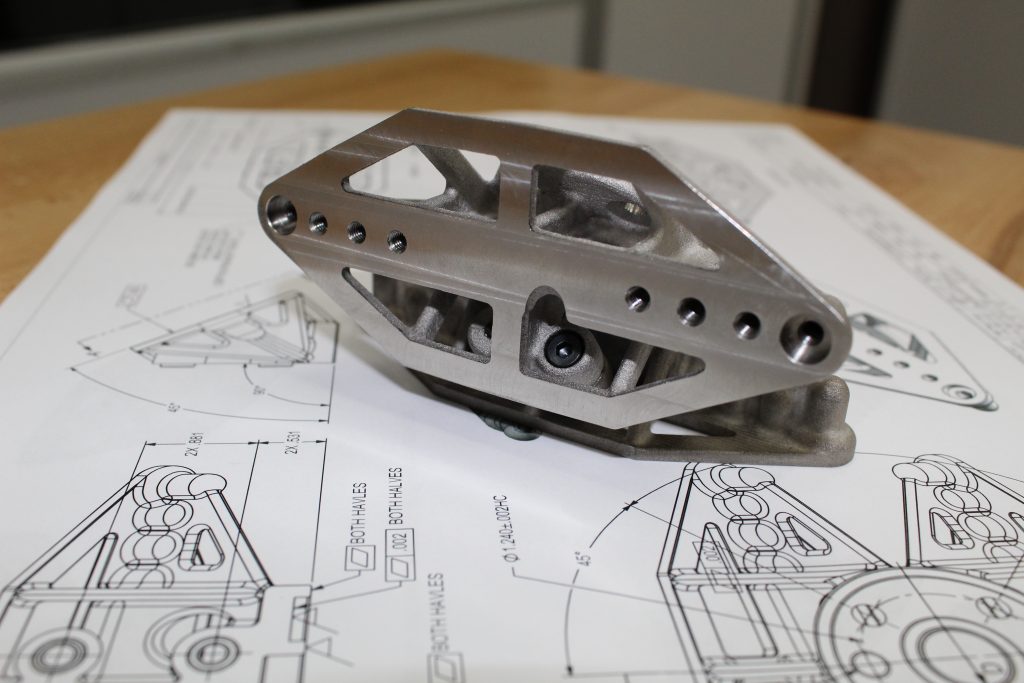 The binder jet 3D printed component was optimized for both weight and costs. Photo via ExOne.