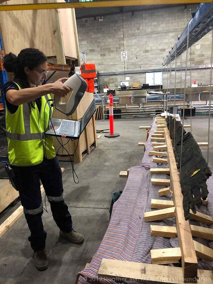 Maritime Archaeologist Renee Malliaros scans a boat timber from the interior hull planking layer of the Barangaroo Boat. Photo via Heather Berry / Silentworld Foundation / Sydney Metro.
