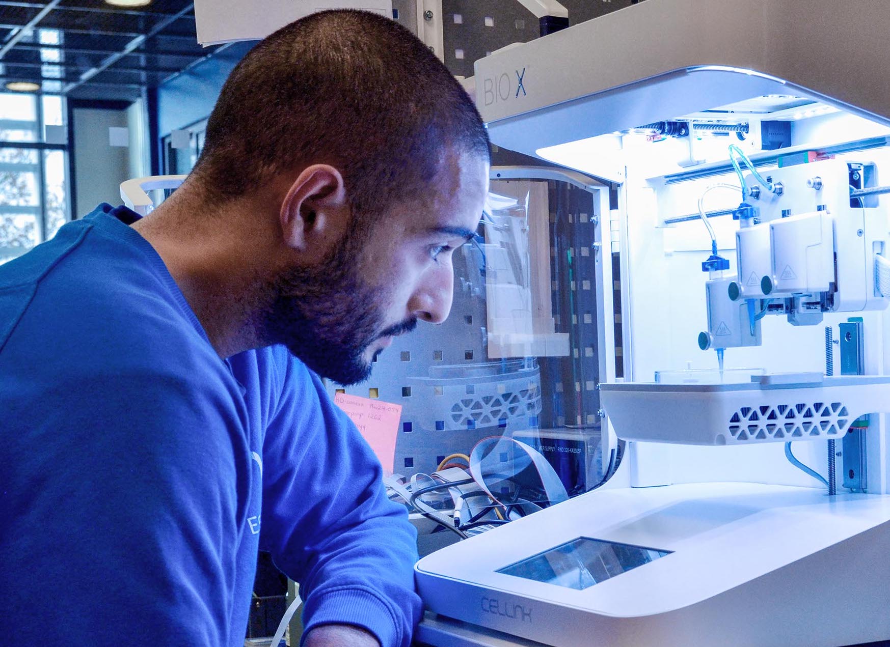 A scientist using a CELLINK 3D bioprinter.