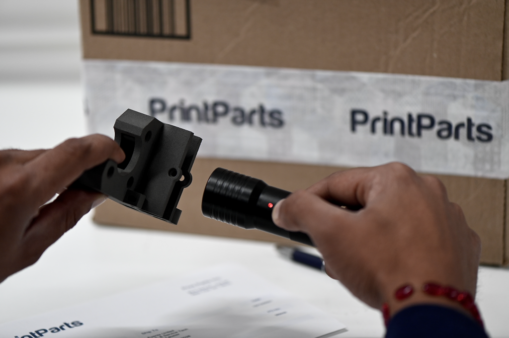 A 3D printed SmartPart being scanned by a handheld smart scanner. Photo via PrintParts.
