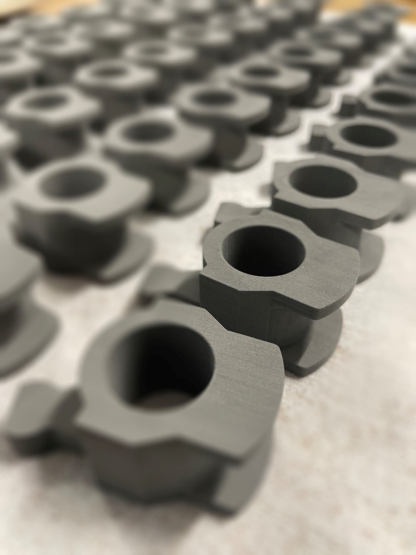 Control Finger for automotive gear boxes, binder jetting printed with DM 4140. Photo via Essentium.