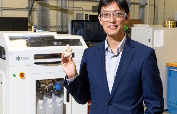 ORNL 科学家 Tomonori Saito 展示了使用新型粘合剂 3D 打印的沙堡。 