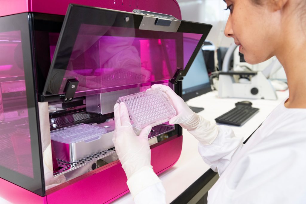 A scientist using Inventia Life Science's RASTRUM 3D bioprinter. 