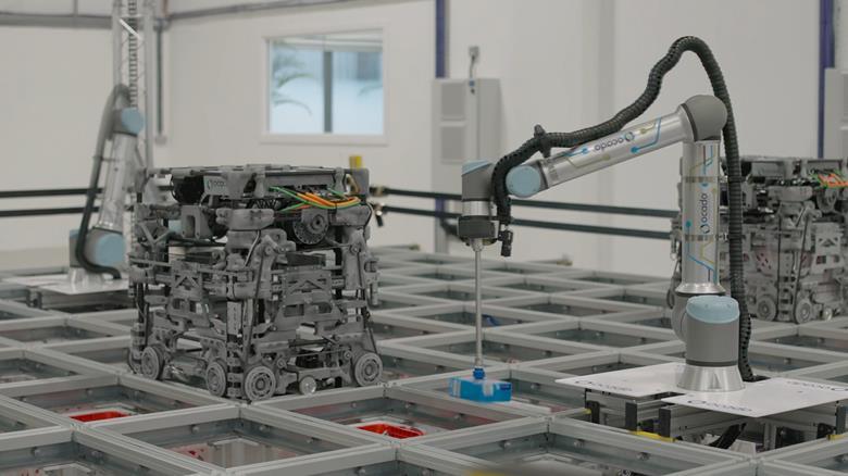 The 3D printed 600 Series bot works in conjunction with a robotic arm to place grocery orders in vans. Photo via Ocado.