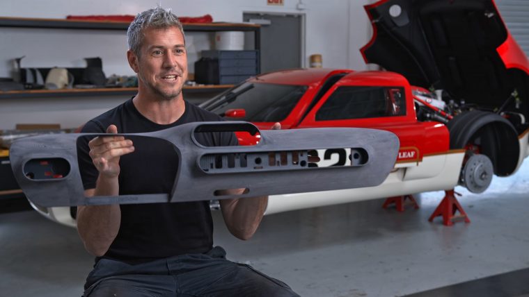 Ant Anstead shows off a 3D printed part for the bodied Lotus Type 62-2 as seen in the Discovery+ documentary, Radford Returns.  Photo via Stratasys.