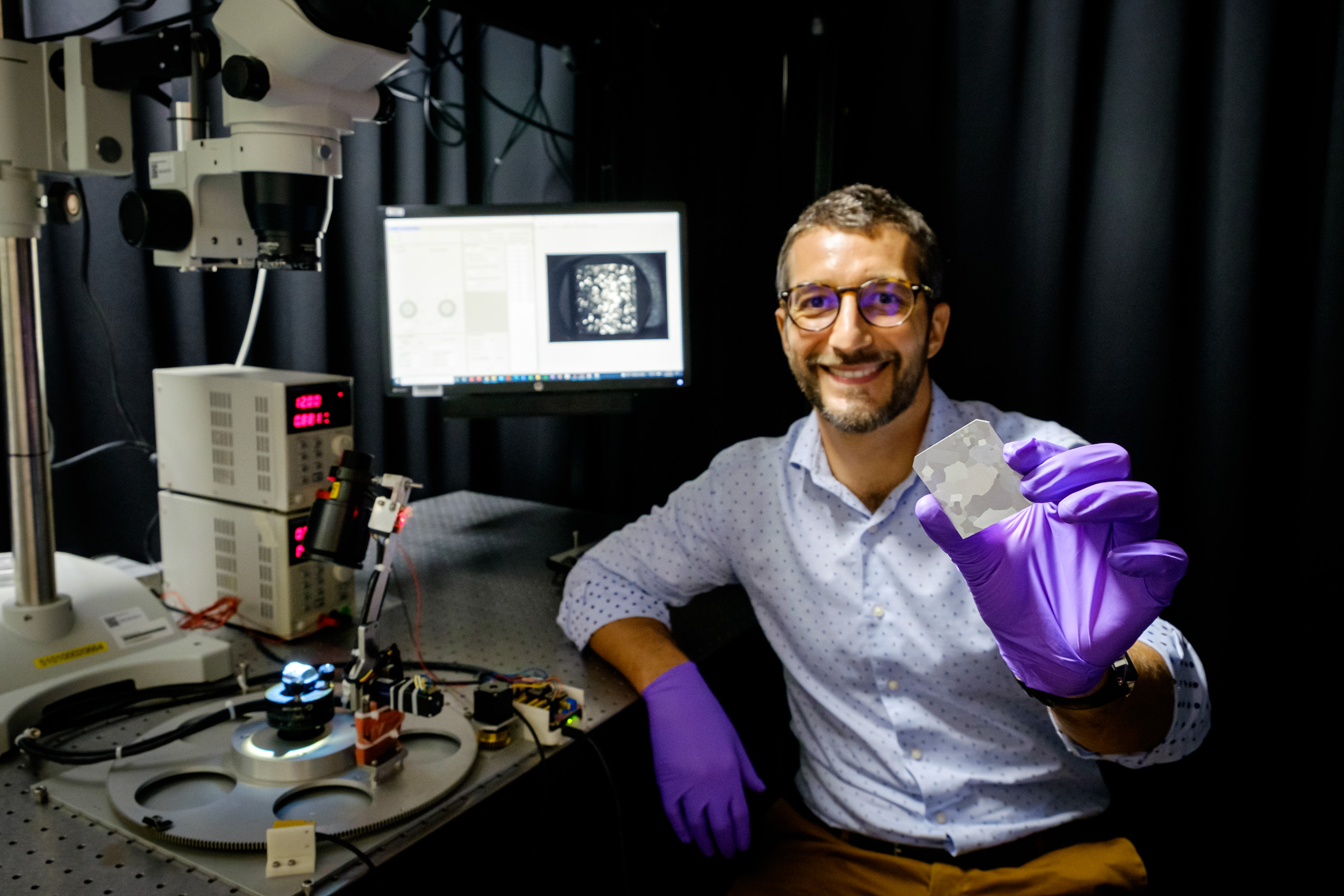 NTU Asst Prof Matteo Seita holding a piece of 3D-printed metal alloy, the properties of which can be easily analyzed in 15 minutes by a new low-cost imaging system that uses an optical camera and machine learning.  Photo via NTU Singapore.
