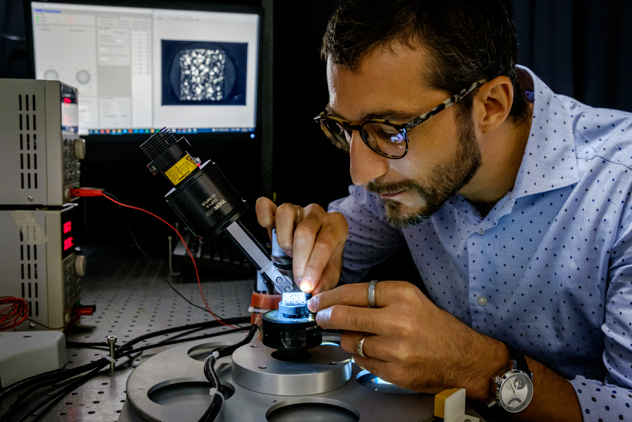 NTU Asst Prof Matteo Seita analyzing a piece of 3D printed alloy for strength and hardness using a prototype imaging system.  Photo via NTU Singapore.