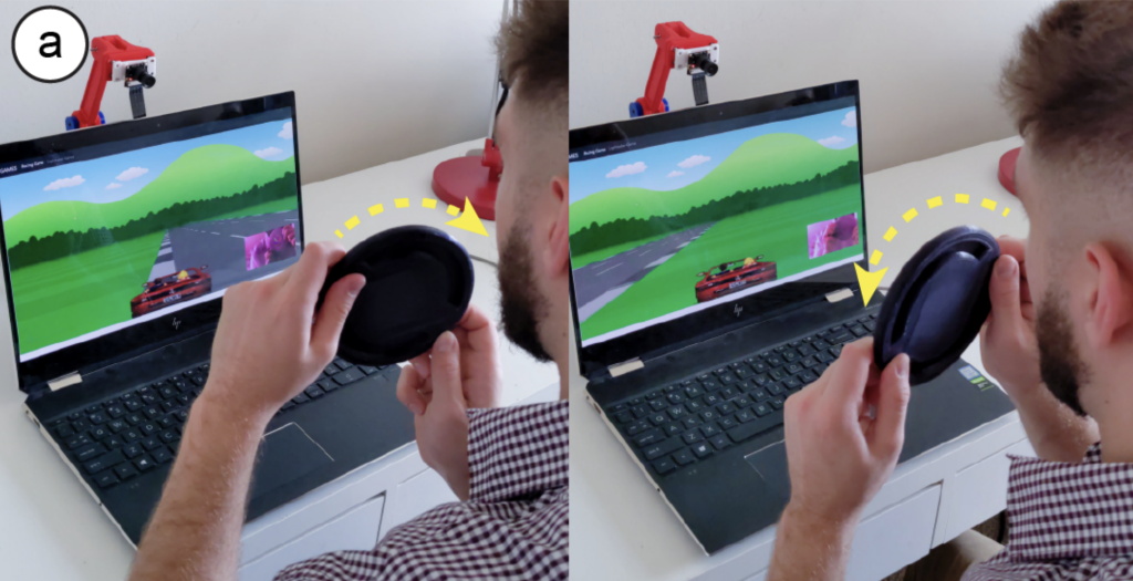 A researcher playing a game with a 3D printed steering wheel controller.