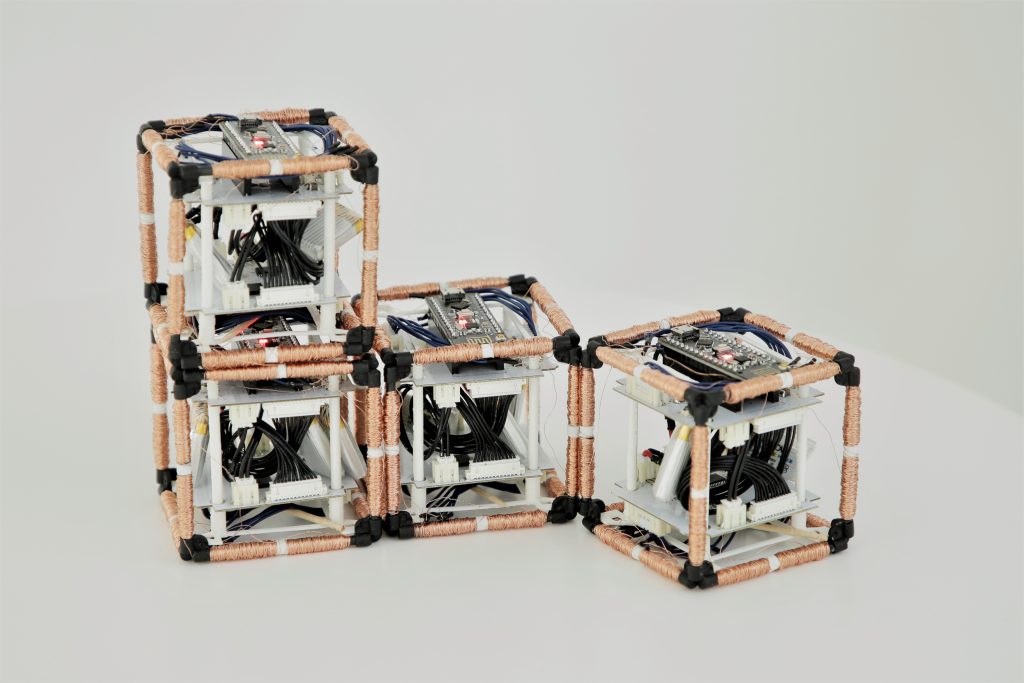 The cubes use electromagnets to configure themselves into different shapes and patterns.  Photo via MIT.