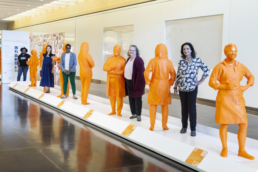 Some of the female inspirations behind the #IfThenSheCan exhibit standing next to their 3D printed statues. 