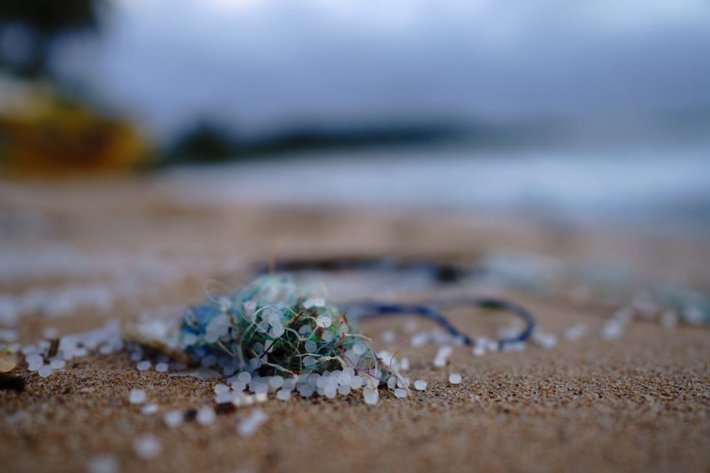 Plastic waste washed up on a beach.  Image via Soren Funk, Unsplash. 