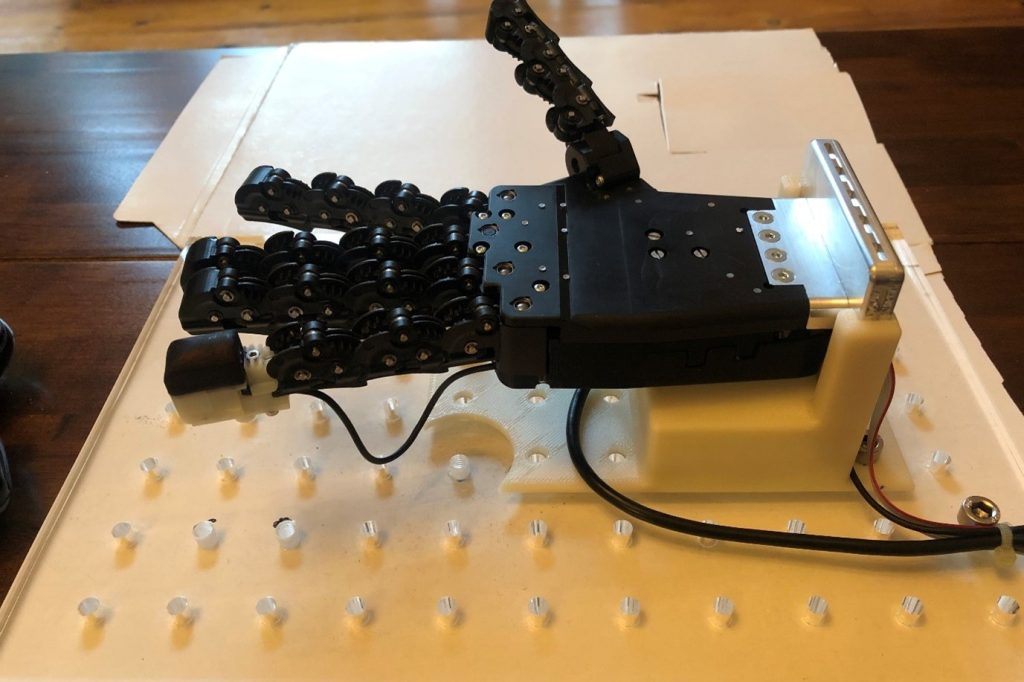 A robotic hand with the TacTip 3D printed sensor on its little finger. 