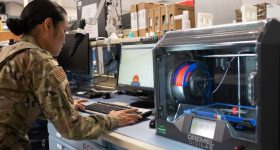 A network technician for the 595th SCS constructs a cover for an alert light with a 3D printer at Offut Air Base. Photo via USAF.