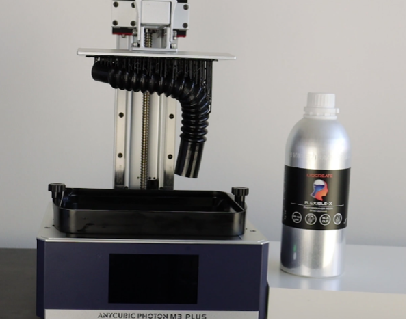 Liqcreate's Flexible-X resin alongside the Anycubic M3 Plus 3D printer. Photo via Liqcreate. 