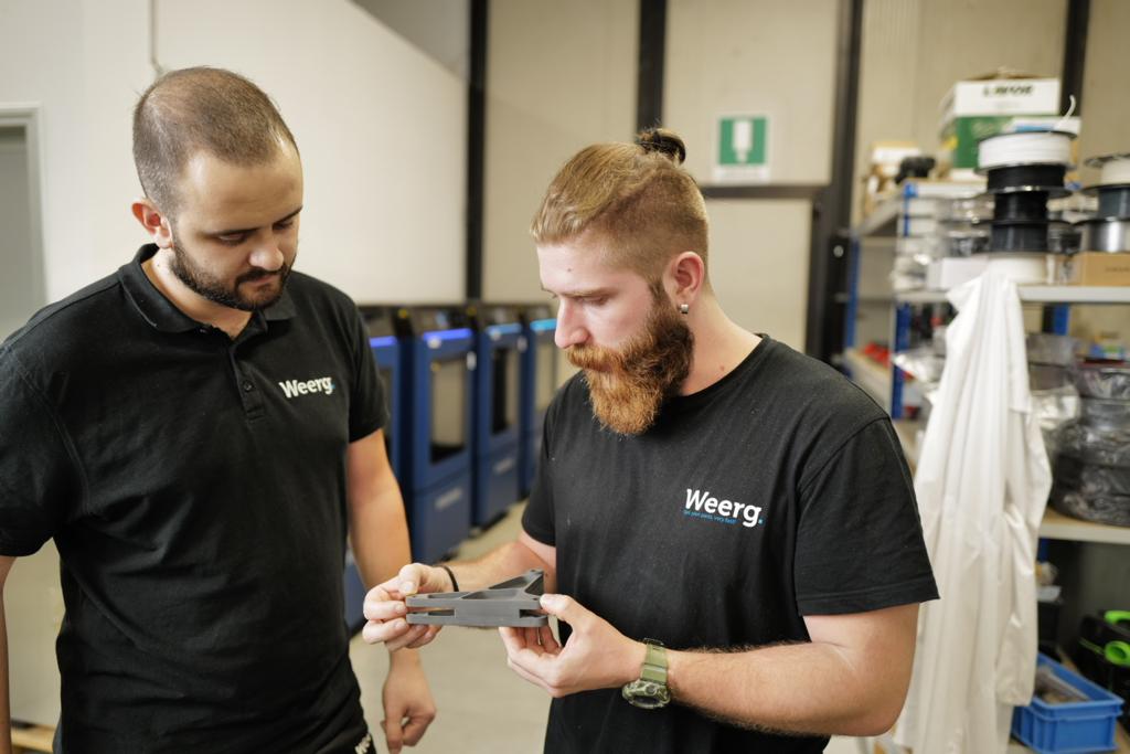 WEERG engineers assessing the quality of an INTAMSYS-3D printed part. Photo via INTAMSYS. 