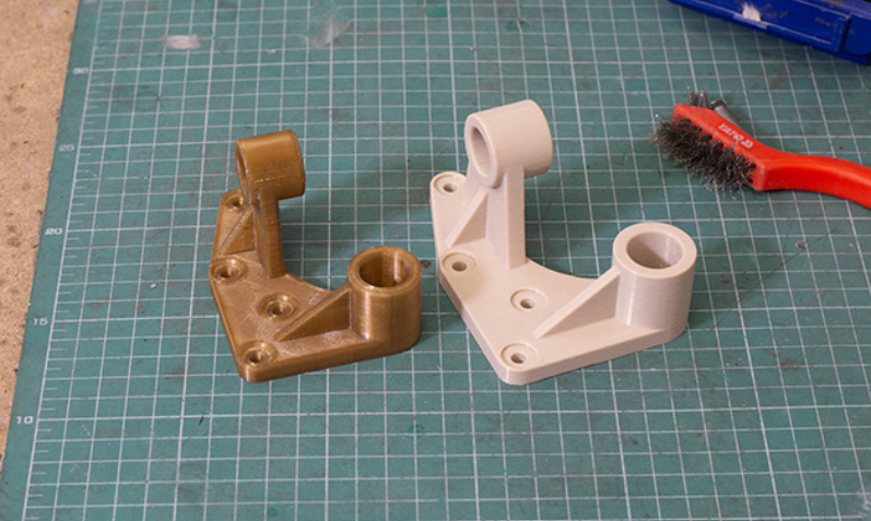 Brackets 3D printed with VICTREX AM 200 on the left and with Z-PEEK on the right. Image via Zortrax.