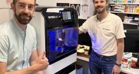 Samuel Guigo (left), radiology and 3D printing technician at CHU de Brest with Stratasys J5 MediJet 3D printer. Image via Stratasys.
