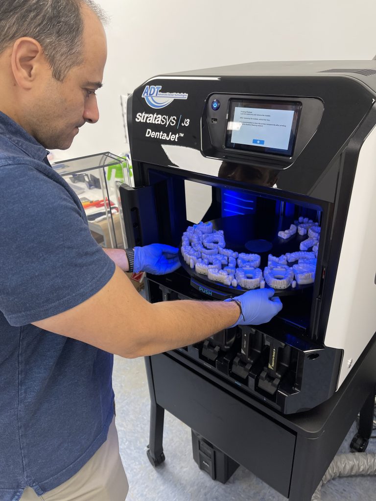 A J3 DentaJet 3D printer at Advanced Dental Technologies. Photo via Stratasys.