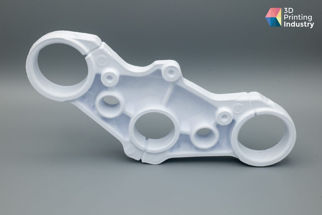 Motorbike triple clamp, 3D scans, and 3D printed part. Photos by 3D Printing Industry.
