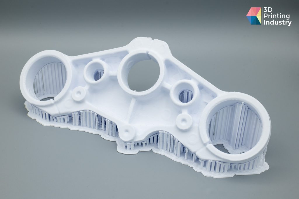 Motorbike triple clamp, 3D scans, and 3D printed part. Photos by 3D Printing Industry.