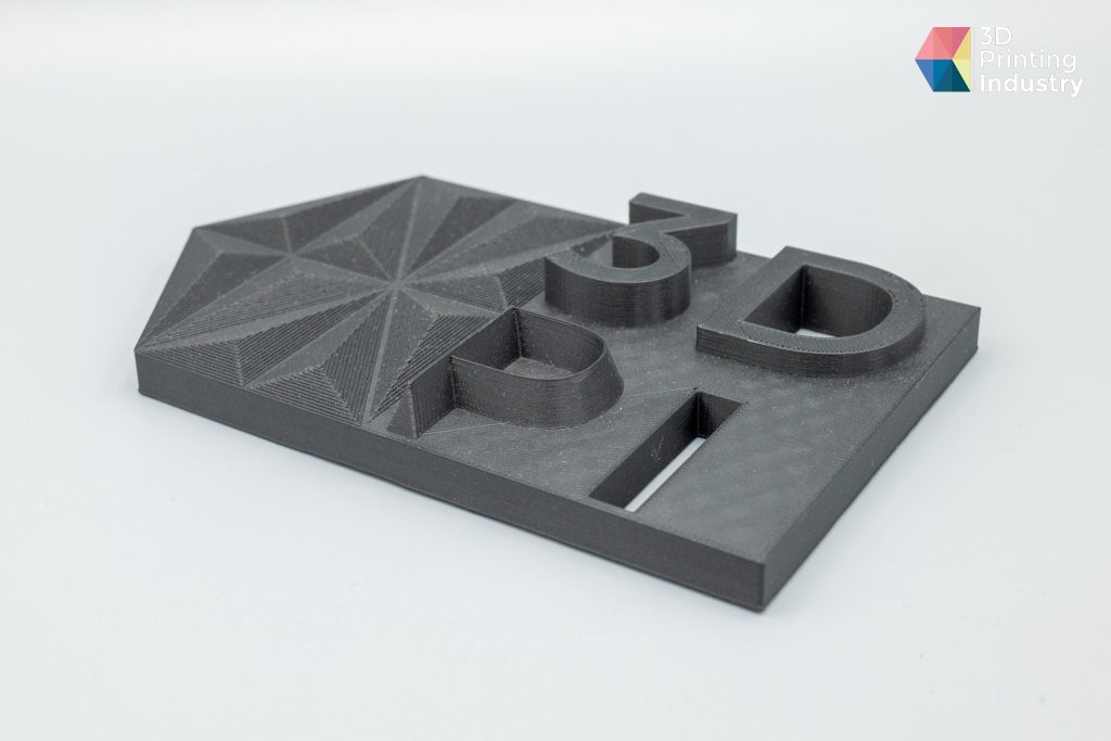 Black pipe mount, 3D printed hand, and 3DPI testing tile. Photos by 3D Printing Industry.