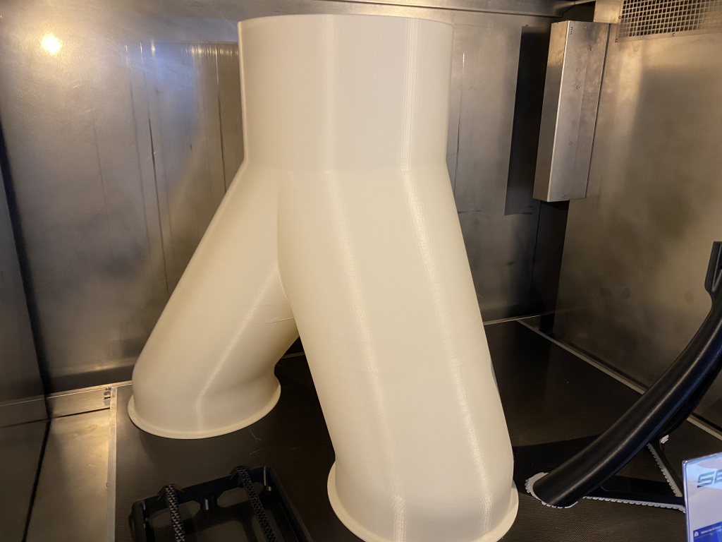 Large-format 3D printed parts inside the Sequoia's heated chamber. Photo by 3D Printing Industry.
