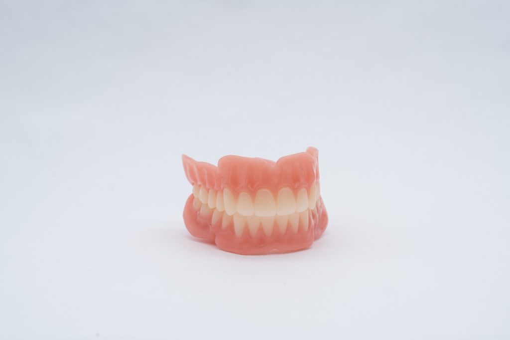 3D printed jetted, multi-material, and monolithic dentures from 3D Systems. Photo via 3D Systems.