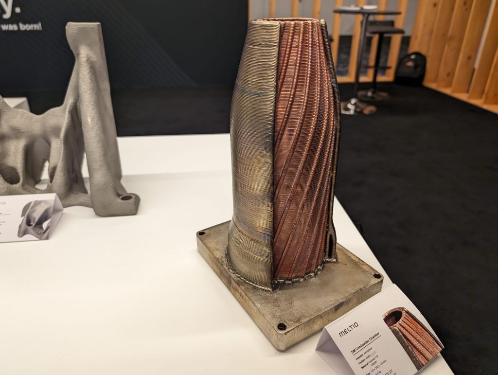 DM combustion chamber 3D printed with the new Meltio M600 on display at AMUG 2024. Photo by 3D Printing Industry.