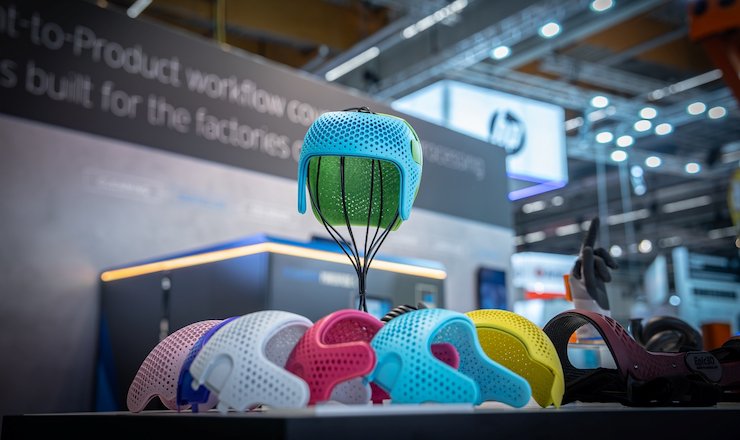 Colorful finished cranial helmets produced with HP MJF technology at Formnext 2023. Photo via DyeMansion.