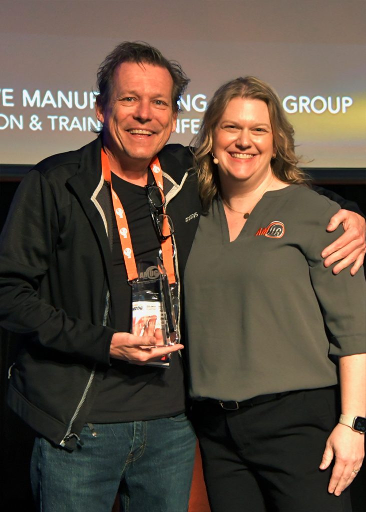 (Left) Mike Littrell of BuildParts by CIDEAS, Inc. receiving the first-place award from Bonnie Meyer for the Advanced Finishing category of AMUG's 2024 Technical Competition. Photo via AMUG.