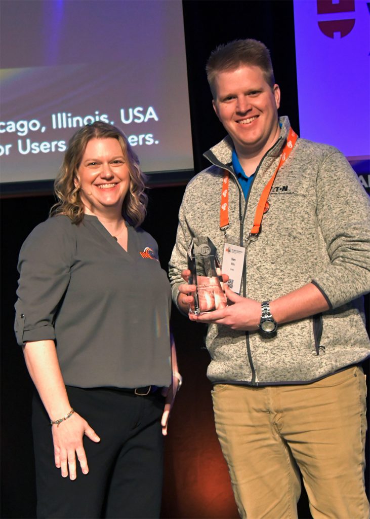 Members' Choice winner, Sam Mills of Eaton (right), receiving his award from Bonnie Meyer in the 2024 AMUG Technical Competition. Photo via AMUG.