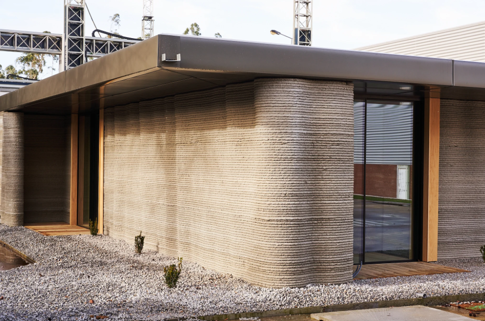 The wavy facade of Portugal's first 3D printed house demonstrates the unparalleled design flexibility that construction 3D printing technology offers. Photo via COBOD.