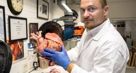 Senior research fellow Richard Arm holding a 3D printed heart model. Photo via Nottingham Trent University.