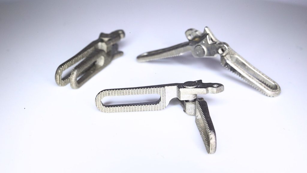 Surgical forceps produced pre-assembled, unpolished with XJet metal additive manufacturing solution. Image via XJet.