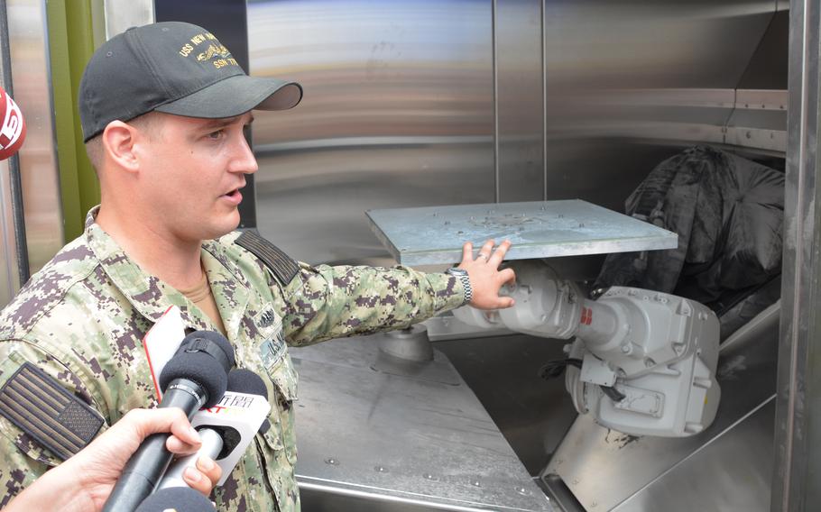 Navy Lt. Joel Hunter and the XSPEE3D 3D printer. Photo via Wyatt Olson/Stars and Stripes.