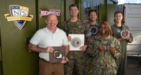 The CAMRE team with the XSPEE3D 3D printer at RIMPAC. Photo via the Naval Postgraduate School.