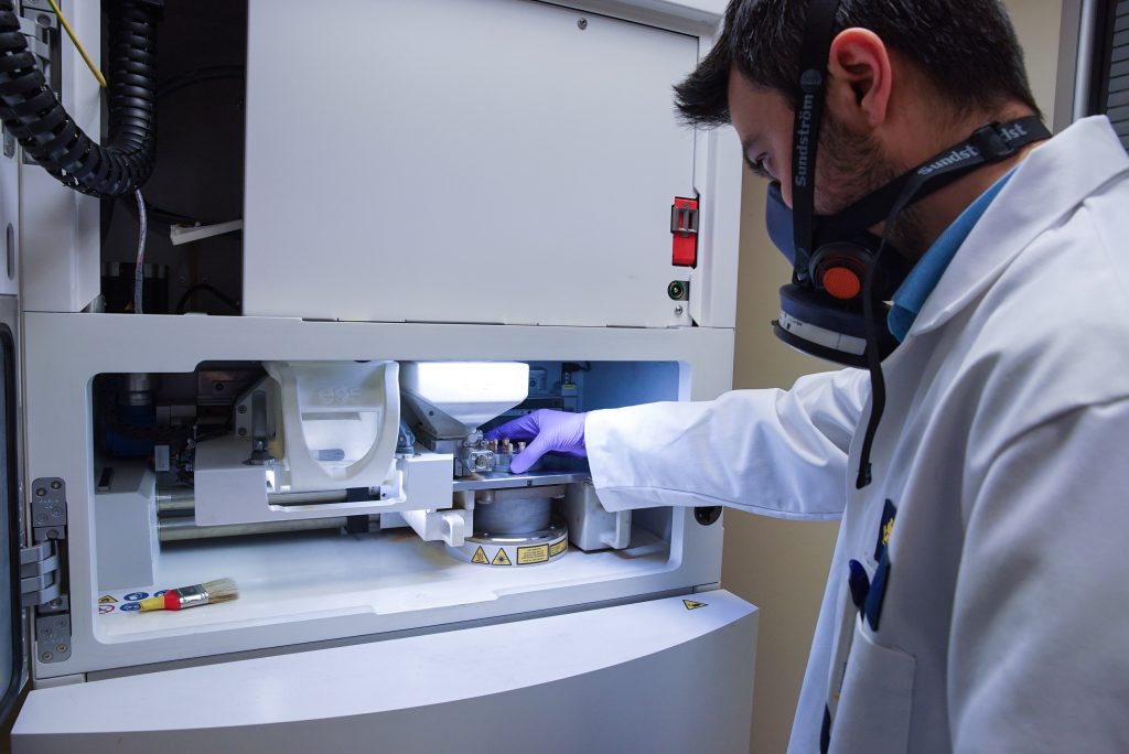 A technician operates an additive manufacturing machine at Cookson Industrial’s facility. Photo via Cookson Industrial.