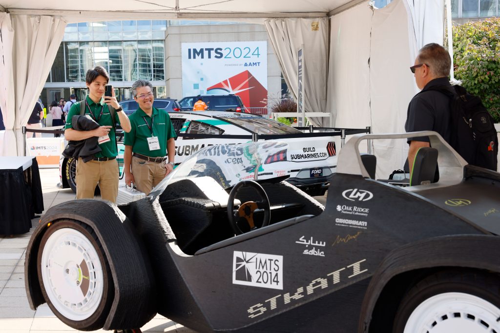 Returning to show a decade later, the Strati 3D printed car. Photo via IMTS.