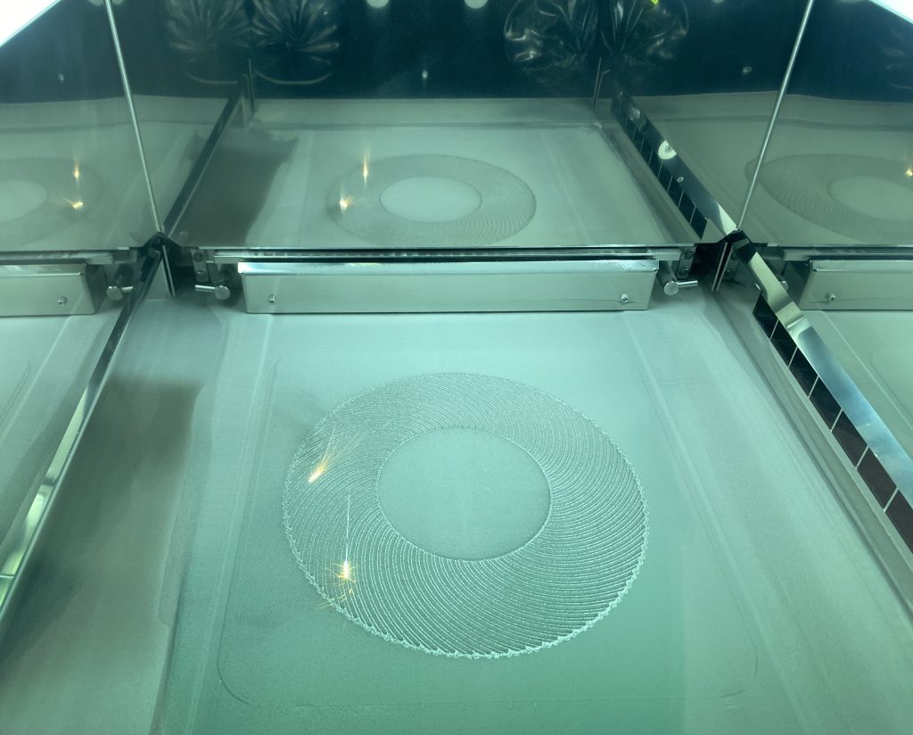 The 3D print bed of Renishaw's new RenAM 500D Ultra. Photo by 3D Printing Industry.