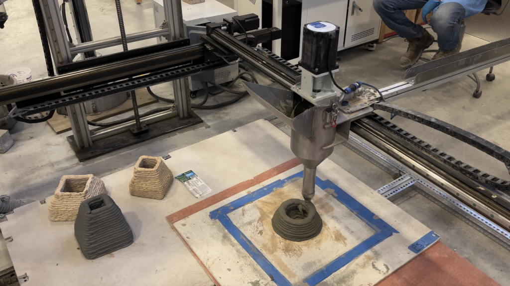 3D printing system depositing self-reinforced ultra-ductile cementitious material for structural applications. Photo via University of New Mexico.