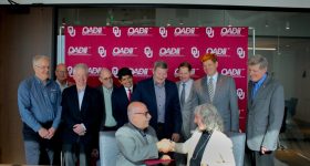 Representatives from the University of Oklahoma (OU) and Oak Ridge National Laboratory (ORNL) reach an agreement. Photo via OU.
