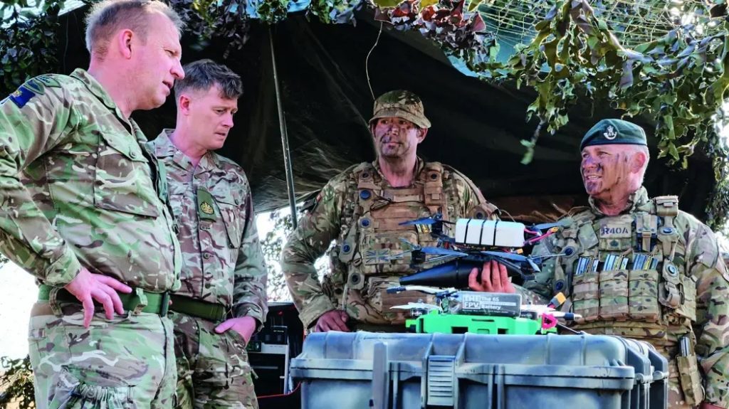 A 3D printed drone, with the British Army's Bambu Lab 3D printer in the background. Photo via the British Army.